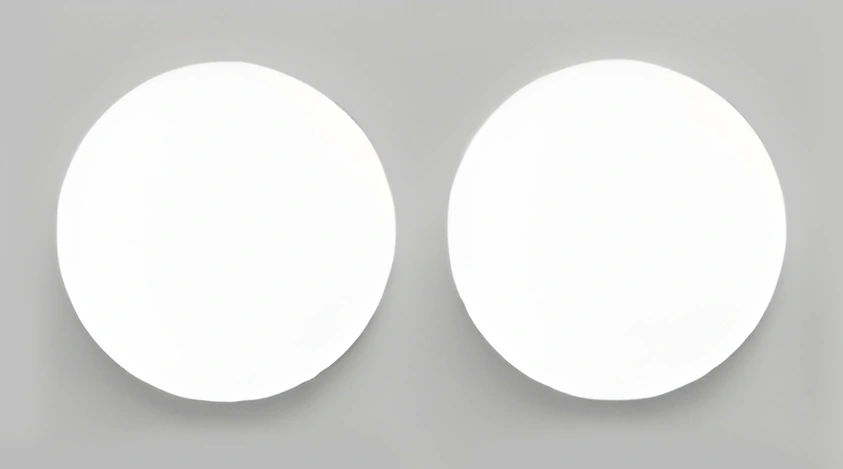 Two round adhesive pads shown separately